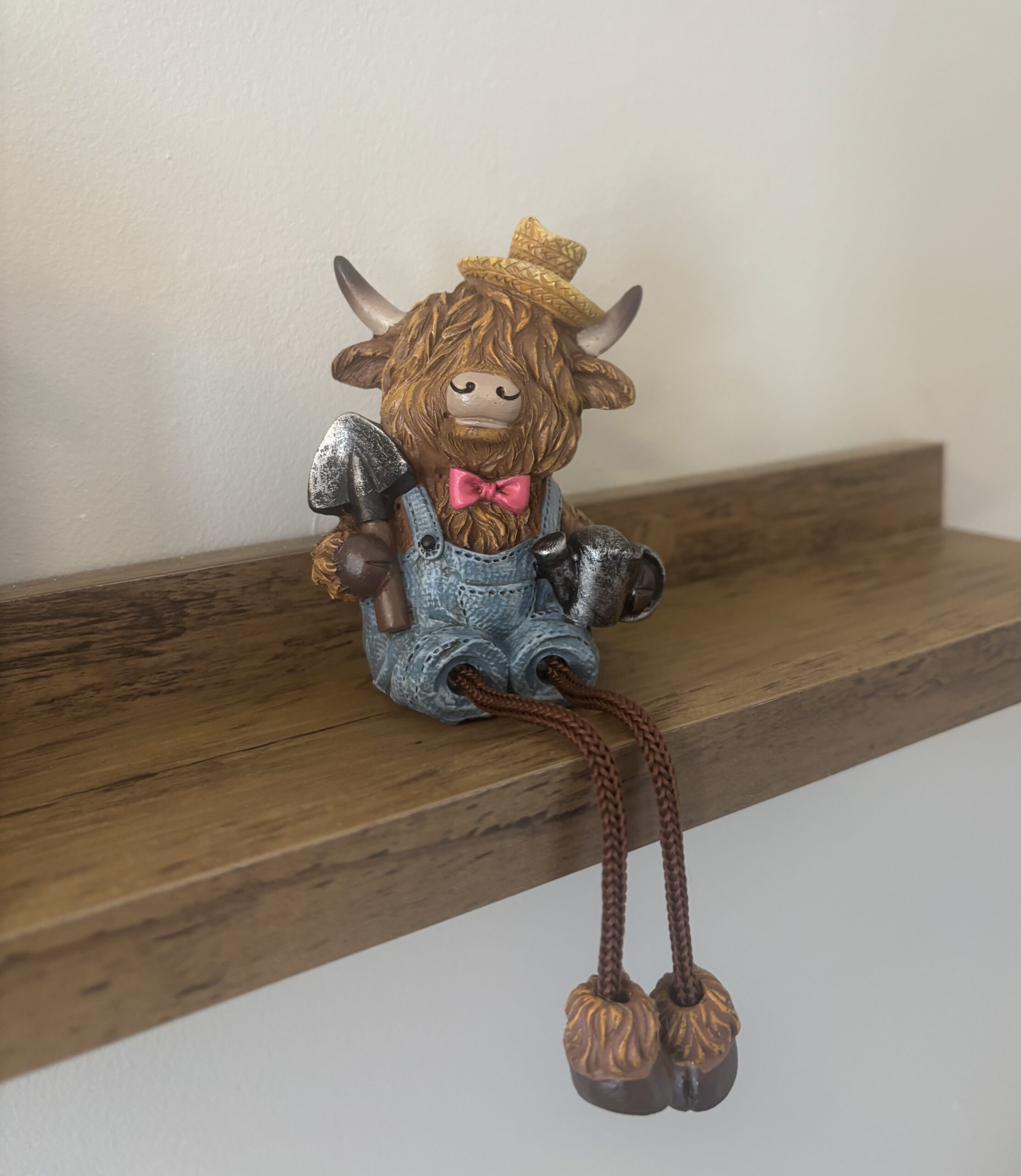 highland cow shelf sitter with shovel